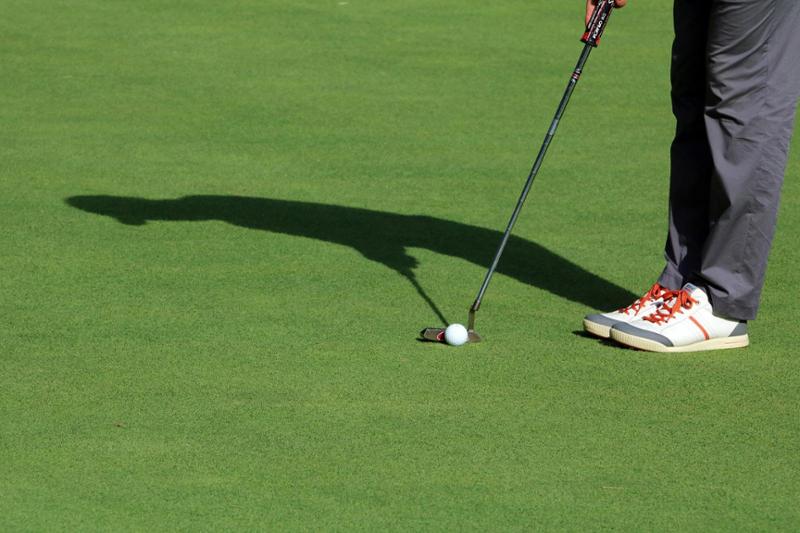 person about to putt golf ball